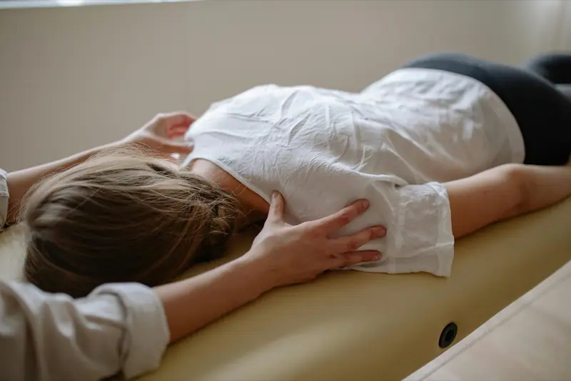 A registered massage therapist treating a client